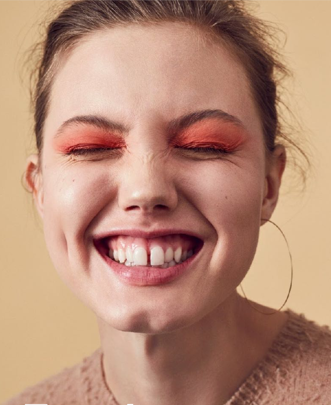 woman's face on light brown background